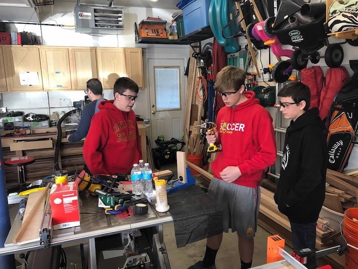 <p>Scouts (from left) Adam Stiner, Austin Mefford, and Cole Hemmes working hard in the shop.</p>
